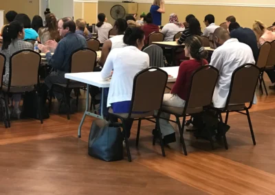 Large group of people seated in a hall during a training or seminar session
